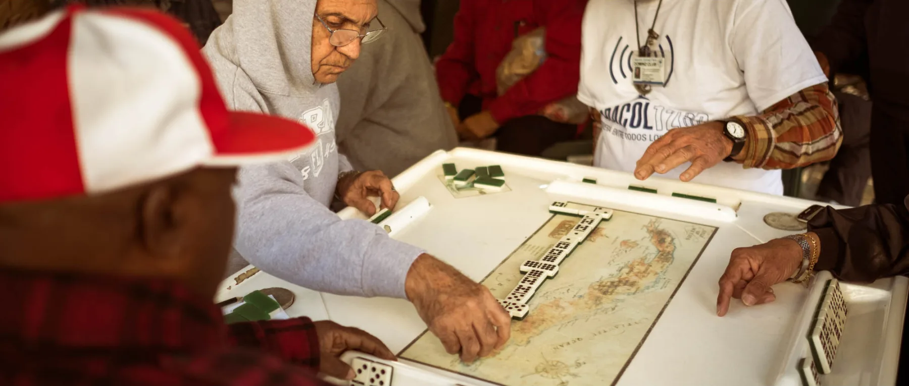 People gathering around domino tables in Little Havana
